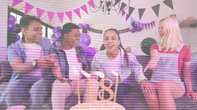 Friends placing cake on table, starting birthday guest wishing and blowing candles on sofa for 18th