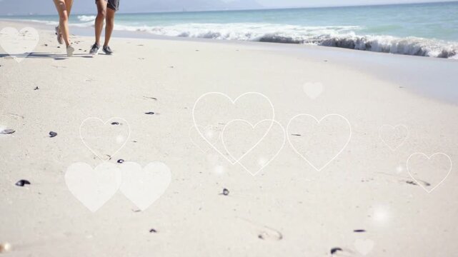 Couple entering left, jogging for fitness along beach while heart-shaped bokeh overlaying sand