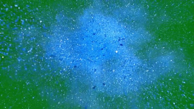 High speed blue particles explode on green background creating dynamic movement and visual impact