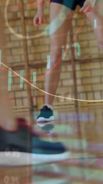Vertical video: Teen athlete pivoting and dribbling in drill as ball entry triggers finance chart