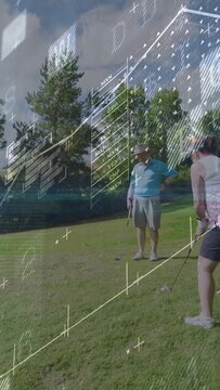 Vertical video: Woman walking to golf ball, lining up swing while man watching AR data guiding shot