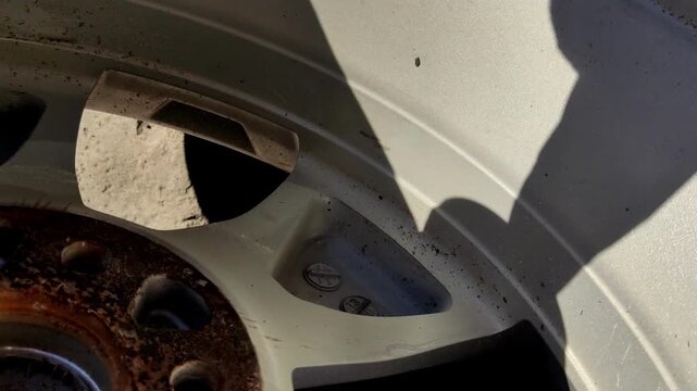 Orange rubber eraser wheel removing adhesive residue from a car.