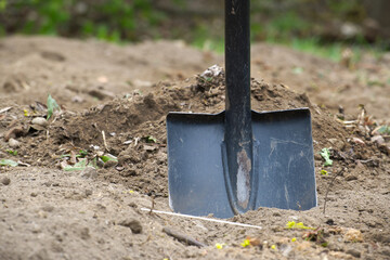 Gardening shovel stuck in freshly dug soil, ready for planting or landscaping © NetPix