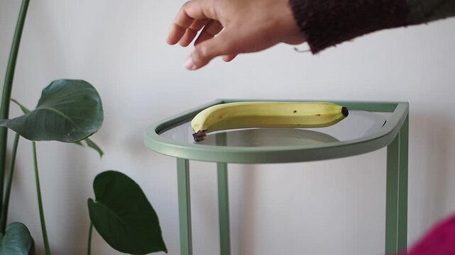 Banana on a table in a simple room setting