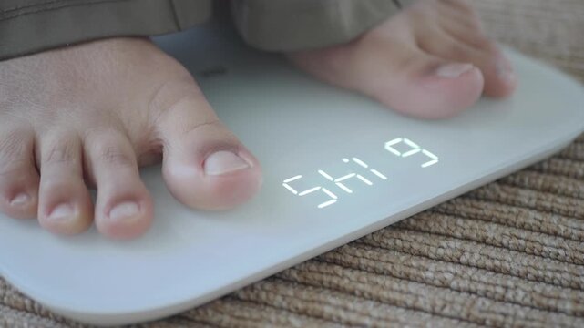 Person weighs themselves on a bathroom scale