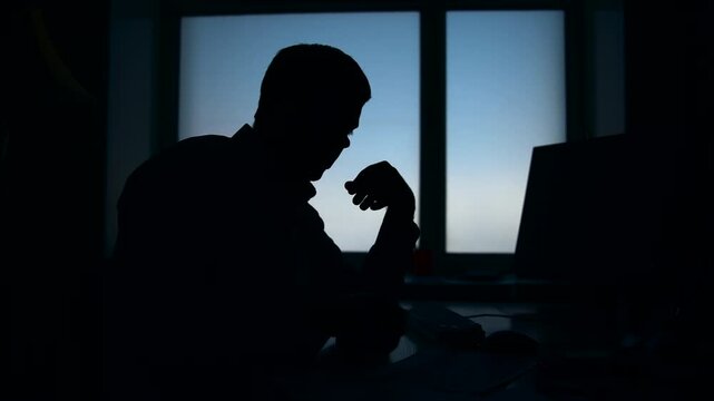 Figure In Dimly Lit Office Communicates Covertly With Someone About Highstakes Case Details . Media