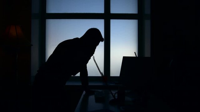 Executive Contemplating Tasks After Hours. Man Reviewing Urgent Work In Dark Office Atmosphere . Media