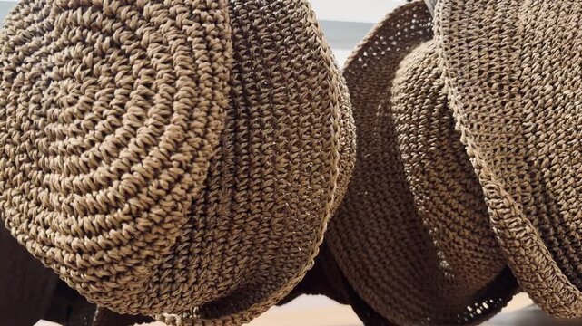 Extreme close-up of woven straw hats texture. Detailed macro view of natural fiber braided pattern, perfect for eco-friendly fashion and summer handicraft background.