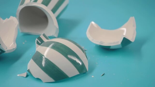 Cup breaks on blue surface during an art project