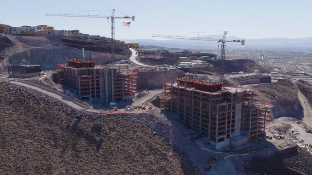 Aerial Rotating View Hillside Construction Cranes in Henderson Nevada