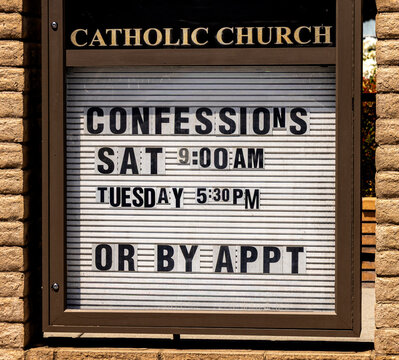 A sign at a Catholic church indicating that confessions can be made on certain days or by appointment