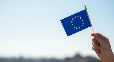 Hand holding european union flag with stars against sky political government international community federation alliance diplomacy caucasus caucasian democracy victory in europe day