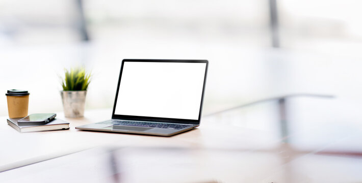 Laptop Mockup with Blank White Screen on Office Desk with Coffee and Smartphone