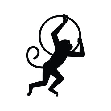 Monkey silhouette jumping through a hoop on a white background