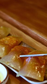 Metal Chopsticks Picking Up Vietnamese Banh Bot Loc Shrimp Dumplings