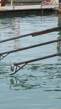 Longtail Boat Propeller Shafts Resting Over Turquoise Water in Krabi