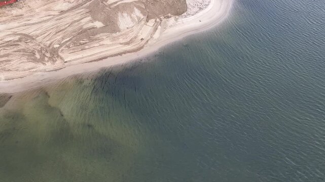Aerial View of Excavator Renovating a Canal Beach in Gold Coast