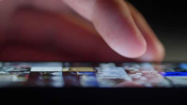 Close up male finger endlessly scrolling smartphone screen in dark room. Digital addiction and screen time concept shows phone addiction digital addiction compulsive scrolling loss of attention online