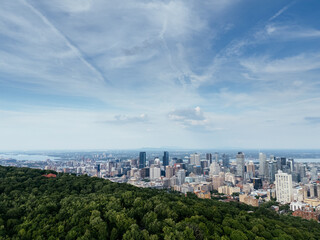 Obraz premium Montreal downtown skyline from Mount Royal with park, lake and greenery in summer, Quebec, Canada. g.