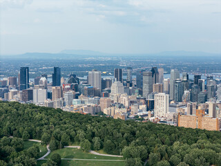 Naklejka premium Montreal downtown skyline from Mount Royal with park, lake and greenery in summer, Quebec, Canada. g.