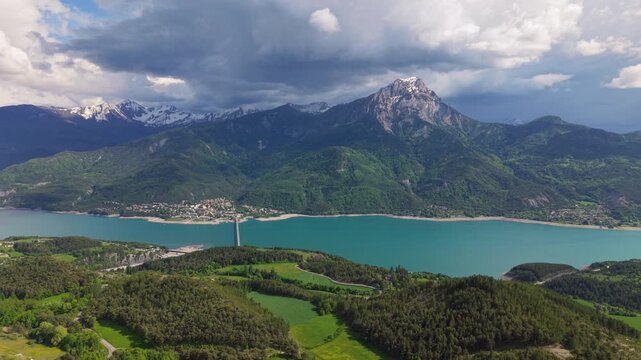 Aerial view of Serre-Poncon lake with Grand Morgon peak and the village of Savines-le-Lac. Durance Valley, Hautes-Alpes (Alps), France