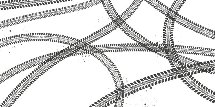 Black tire tracks and vehicle wheel marks overlapping on a flat surface
