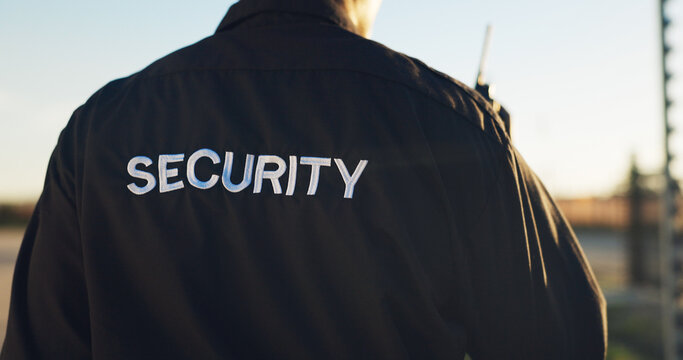 Back, guard and security with uniform outdoor for surveillance, authority and perimeter protection. Male person, radio and bodyguard services for access control, restricted area and threat detection