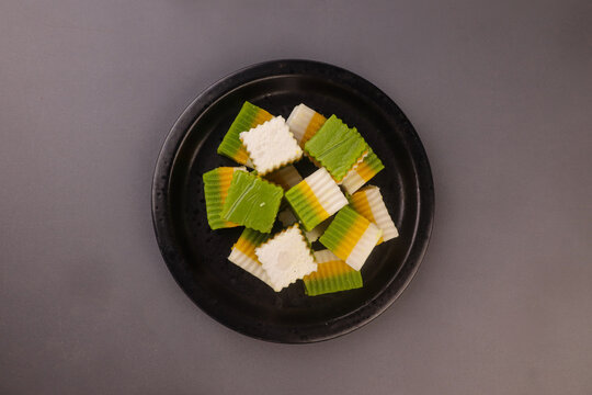Talam labu is a traditional Southeast Asian layered dessert made from pumpkin, coconut milk, and rice flour, known for its soft and silky texture. 