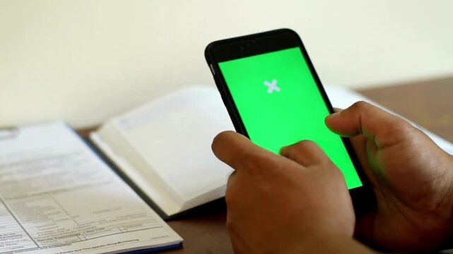 using Smartphone with Green Mock-up Screen green chroma key screen, hand gesture scrolling on device, empty space template