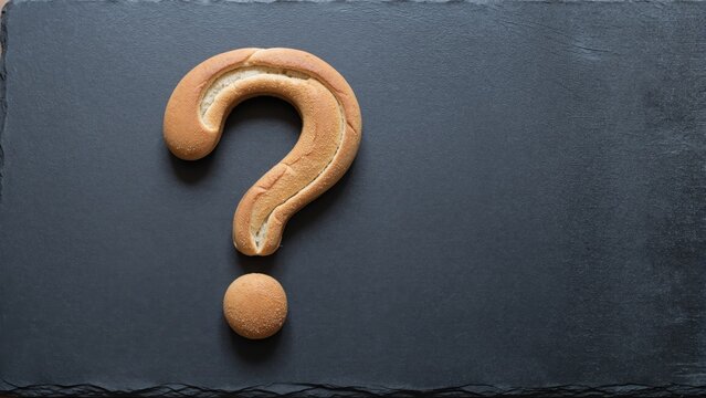 Question Mark Bread on Slate: A creative culinary depiction features a question mark formed by artfully arranged bread on a dark slate, presenting a thought-provoking image