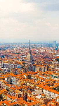 Vertical video. Turin, Italy. Mole Antonelliana - Majestic building from the 19th century. Panorama of the city. Summer day. Drone footage. Rich colors