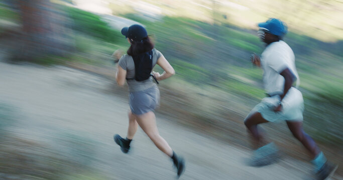 Speed, running and couple with motion blur outdoor for fitness, cardio wellness or race. Sport, marathon practice or people on runner path in forest for health, exercise or workout together