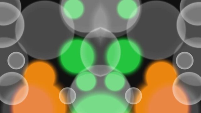 Vibrant green and orange orbs float amidst gray circles on black