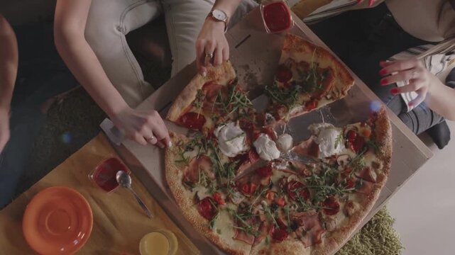 pizza margarita top view, several people take apart pieces of pizza from the board sharing delicious lunch on wooden table background italy cuisine