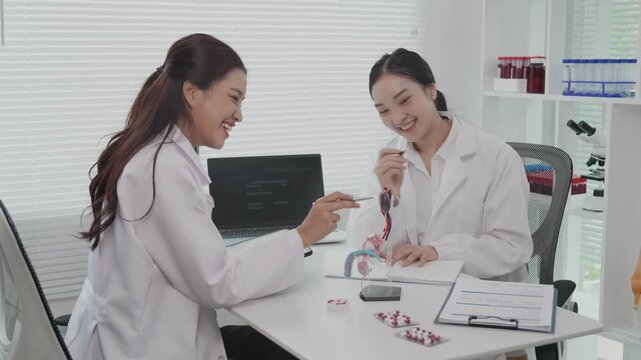 Two Asian female doctors conducted research on enlarged prostate.