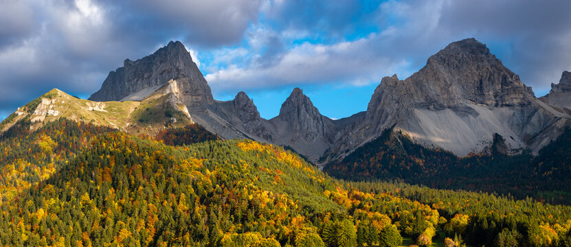 Aerial view of La Jarjatte in the Devoluy massif, Drome, France. Autumn forest, limestone peaks and alpine valley in the Vercors Regional Natural Park, French Alps