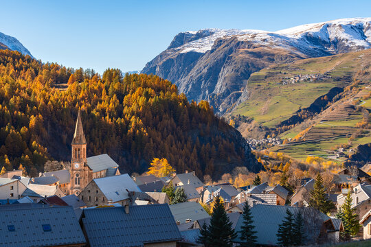 Autumn view of Villar d&rsquo;Arene with hillside villages of Les Terrasses and La Grave in the distance. Romanche Vallley, Ecrins National Park, Hautes-Alpes, France