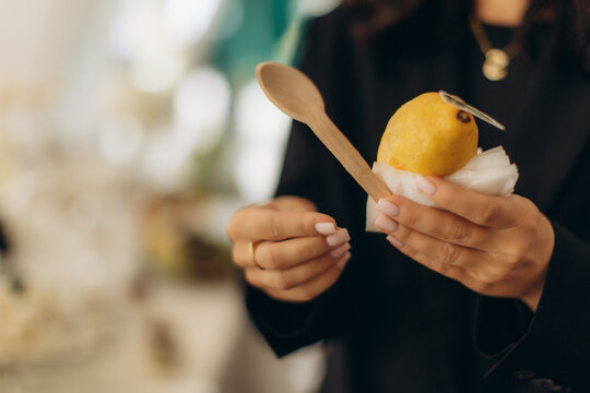 Woman's hands holding mango street food dessert