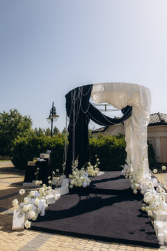 Outdoor wedding arch with black and white theme