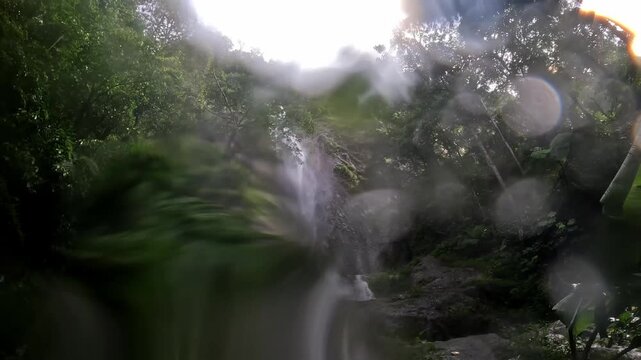 Dolo waterfall, Kediri, East Java, in Indonesia flows rapidly in the morning. Timelapse of waterfall.