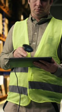 Vertical Video Industrial worker scanning labels of cardboard boxes for inventory accuracy. Distribution center staff ensure shipment details with AWB tags and efficiency in e-commerce order