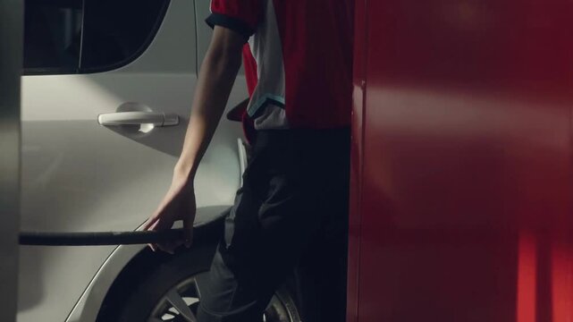 Refueling a car at a gas station. Hand holding and recording the process. Fuel, gas station, petrol prices concept. Gasoline, gas, fuel, petroleum
