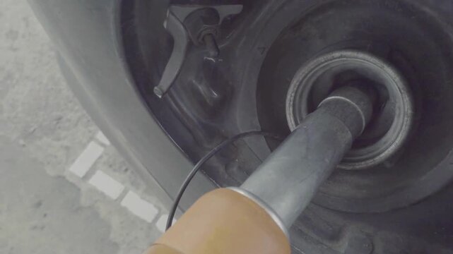 Closeup of man filling gasoline fuel in his car at the gas station Filling car petrol. Pump gas fuel at gasoline oil station for nozzle tank pollution