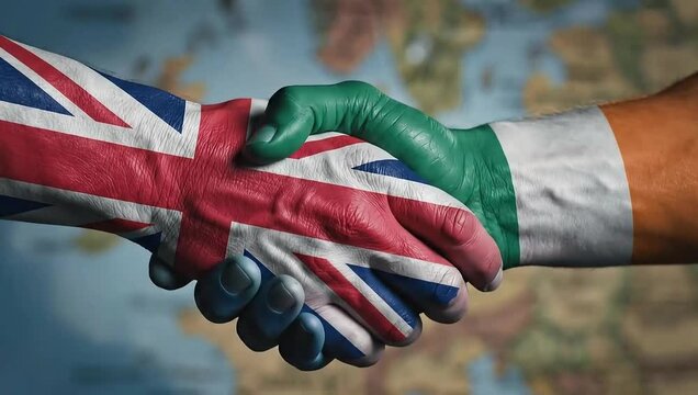United kingdom and ireland flags handshake on world map background.