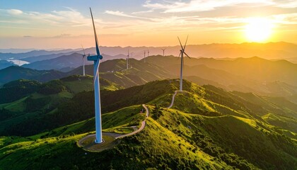 Naklejka premium A vibrant summer sunset over mountain peaks illuminates a landscape of green meadows and wind turbines generating clean ecology power under a cloudy sky