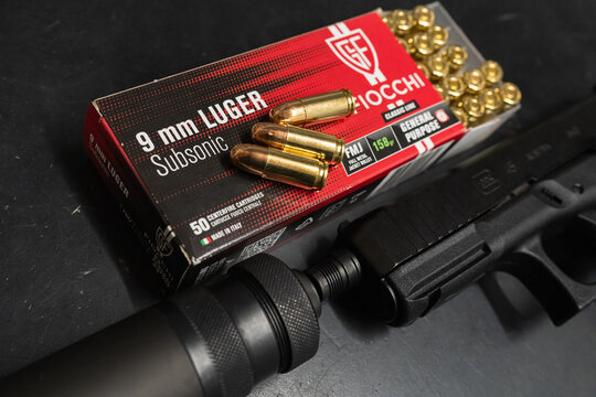 BALTIC STATES - APRIL 29, 2026: 9mm Luger Subsonic Ammunition and Suppressed Handgun on a Flat Surface, Detailed View of Quiet Firearm Equipment and Heavy Grain Cartridges.