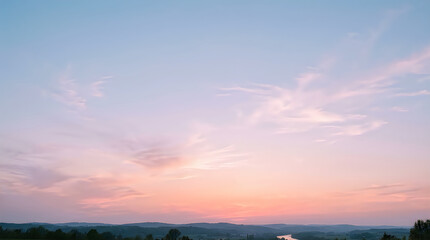 Fototapeta premium Soft Pastel Sky Gradient at Sunrise with Wispy Clouds Over Rural Landscape