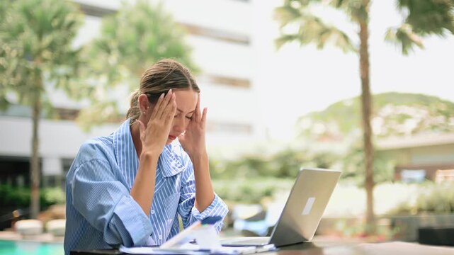 Stressed business woman working on laptop, talking on phone. Remote work pressure, deadline, burnout, anxiety, multitasking