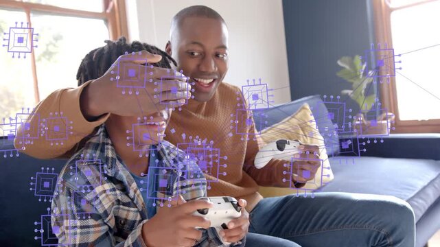 Dad reaching over boy during gaming, purple chip overlay on pads, teasing covering and showing eyes