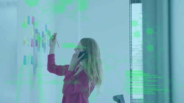 Vertical video: Answering call, woman in pink blouse moving notes on board with HUD while planning